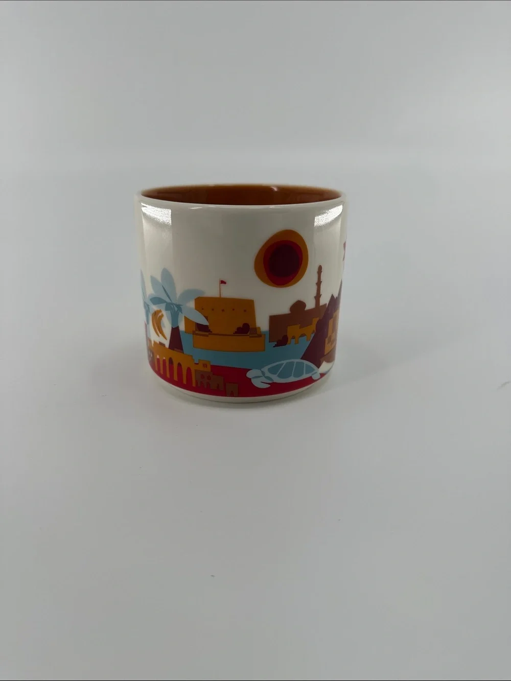 Starbucks Oman Cream Cityscape Mug with Orange Interior and Red Accents